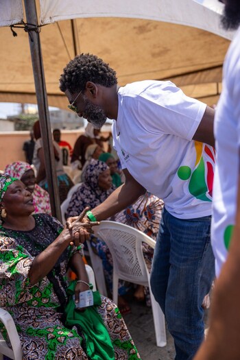 Kevin Okyere interacting with community members during the Foundation World Food Day Outreach