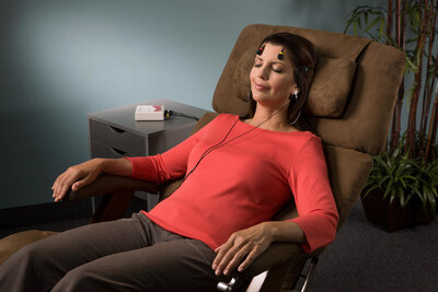 A female client relaxing in a zero-gravity chair while experiencing the BrainEcho™ process from Cereset®.