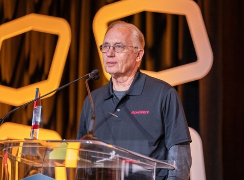 PostNet Round Rock, Texas, owner Greg Claiborne accepts the printing and shipping solutions company's 2025 Franchise of the Year Award at its 31st annual convention held in Chicago.