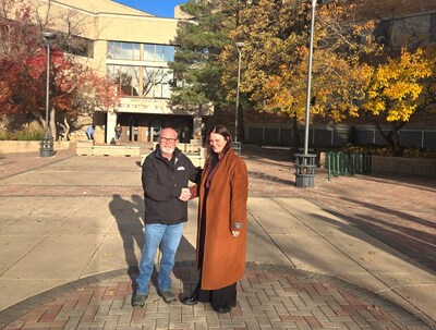 SCMMA President Greg Hippe (left) and Society President Rebecca Caron (right) shake hands in front of Saskatoon City Hall to celebrate the successful merger vote. (CNW Group/Society of United Professionals)