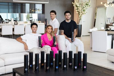 Real Housewives of Miami star, Larsa Pippen, with her children, Preston, Justin, and NBA player, Scotty Pippen Jr alongside several Aroma360 NBA Team Mini Pro Diffusers.