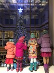 Children looking at giant Christmas tree