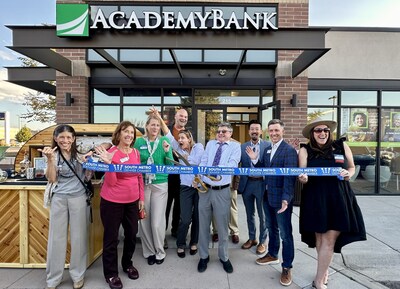 Community leaders joined Academy Bank associates and clients to celebrate the opening of Academy Bank’s new branch at 40 W. Littleton Blvd. in Littleton, Colorado. Attendees included Littleton Mayor Kyle Schlachter, City of Centennial Council Member Richard Holt, and representatives from the South Metro Denver Chamber of Commerce, which partnered in organizing the event. Branch Manager Matthew Diehl (with scissors) cut the ribbon to mark the official opening, attended by approximately 90 guests.