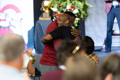 Clarksville Christian Girls Basketball Coach Trenton Hassell hugs his former Minnesota Timberwolves teammate Ervin Johnson who traveled to Clarksville to attend the surprise ceremony.