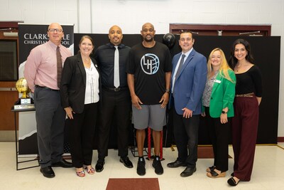 Coach Trenton Hassell (center) is surrounded by Clarksville Christian School leaders as they celebrate his award. Coach Trenton Hassell (center) is surrounded by Clarksville Christian School leaders as they celebrate his award.