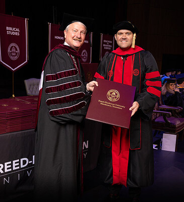 FHU President David R. Shannon presents Keith Harris with his doctorate in ministry in May 2025.