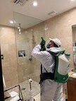 FixMold technician performing mold treatment and water damage restoration in a residential bathroom using advanced equipment.