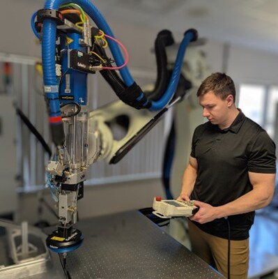 Nicholas Switalski, a Coherix dispensing system engineer, programs a Yamaha robot for use with a Coherix 3D inspection system. Nicholas Switalski, a Coherix dispensing system engineer, programs a Yamaha robot for use with a Coherix 3D inspection system.