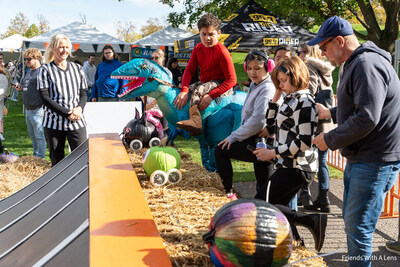 Turning Pointe Autism Foundation student racers get their pumpkins ready to roll at the starting line during the annual Pumpkin Race in Naperville. This community event raised more than $35,000 and welcomed over 350 attendees. Turning Pointe Autism Foundation student racers get their pumpkins ready to roll at the starting line during the annual Pumpkin Race in Naperville. This community event raised more than $35,000 and welcomed over 350 attendees.