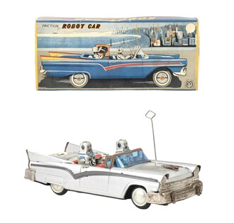 Extraordinarily rare ET (Japan) tin friction &#39;Honeymoon&#39; Robot Car, one of possibly only two in existence that retain their original pictorial boxes. Silver convertible has blue windshield, large grille and tailfins typical of midcentury American cars. Lithographed robot driver plus robot passenger in back seat. Complete, all-original, including hubcaps. Box lid artistically depicts car in full color against setting reminiscent of Chicago&#39;s Lake Shore Drive. Estimate: $40,000-$80,000