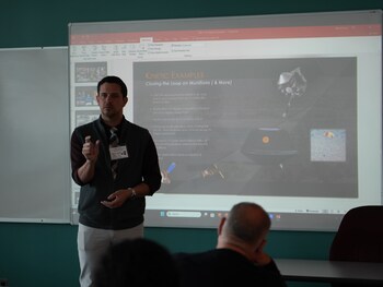 Michael Wroblewski delivers a presentation on munition technology.