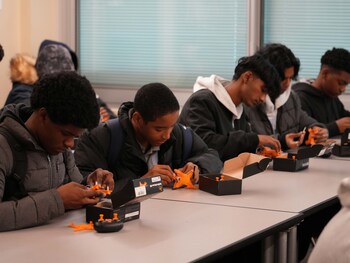 High school students work on creating their own drones.