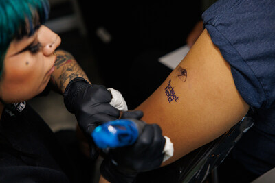 YNAB Fan Fest attendee getting tattoo.