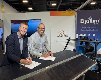 Elysium EPL Director Michael Mitchell and Seasats CEO Mike Flanigan sign their partnership agreement at Indo-Pacific 2025 alongside a Seasats Lightfish ASV.
