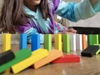 Child playing with colorful dominoes
