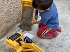 Child playing with toy trucks