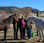 Audra Deputee Kolodziejski and her mother, Rebecca Deputee standing with two of the horses they breed on their family's land.