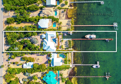 The property enjoys a large lot of approx. 0.86 acres (including riparian rights extending into the waterway) with 120 ft of ocean frontage. Its 200-ft boat dock includes an impressive, 120,000-lb lift for vessels up to 75 ft in length, plus 2 smaller lifts for additional watercraft. FloridaKeysLuxuryAuction.com.