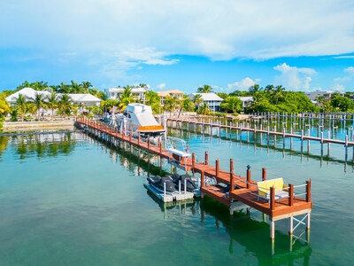 The property’s impressive dock and boat lift, as shown from the waterway. According to listing broker Lisa Swanson, the 120,00-lb lift is the largest she has ever seen at a private residence in the Florida Keys. FloridaKeysLuxuryAuction.com.