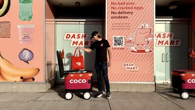 DashMart employee prepares a Coco robot for delivery.