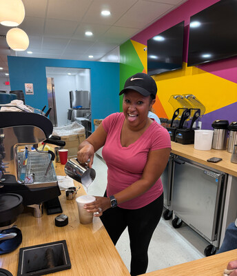 Owner Melanie King prepares a coffee drink behind the counter at her new Drip N Sip Coffee & Tea in Hampton, Va.