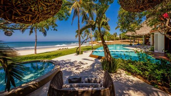 Private beachfront infinity-pool villa available through Punta Mita Vacation Rentals.