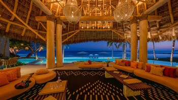Elegant oceanfront living room in a Punta Mita beachfront villa with five-star amenities.