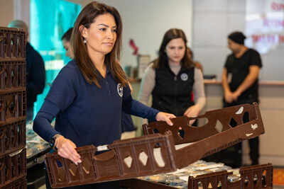 Scholarship America's Marcela Zarate helps as the organization donates more than 200 meals from its postponed gala event to students at the University of the District of Columbia. Photo by LAFlicks.