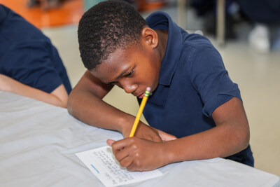 A National Heritage Academies student writing a thank-you note for Project Gratitude.