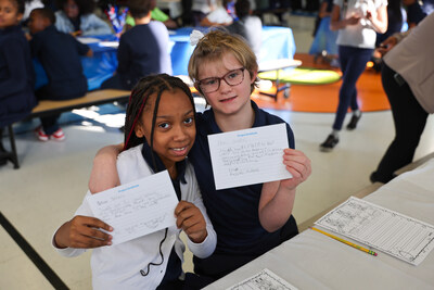 Two students show off thank-you notes at South Canton Scholars.