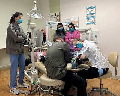 Clinicians at Cottonwood Smiles Dentistry provide care to a local veteran, who is wearing noise-canceling headphones, which are part of the sensory sensitivity kits distributed to offices by the PDS Health Foundation.