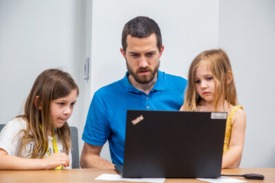 A Kimley-Horn parent shares a fun moment with his children during a Bring Your Child to Work Day celebration. A Kimley-Horn parent shares a fun moment with his children during a Bring Your Child to Work Day celebration.
