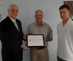 Brian King, President of HSE Consulting Services, receives the Patriotic Employer award from Thomas Shaw (left) as HSE Consulting employee and guard member Alex Forsyth (right) looks on.