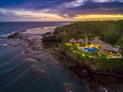 The Signature Villa glows as the sun sets over the South Pacific Ocean. FijiLuxuryAuction.com.