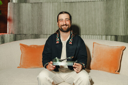 Noah Kahan receives the SoundExchange Hall of Fame Award backstage at Maryland’s Merriweather Pavilion before his headlining set at the All Things Go festival. (Photo credit: Kevin Murrugarra/Respective Collective)