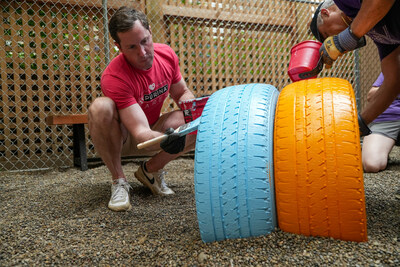 Purina and RedRover, in partnership with Greater Good Charities, brought team members to YWCA Greater Cincinnati – a 2025 Purple Leash Project grant recipient – to help convert an existing building into six pet-friendly rooms and outfit them with specialized pet equipment, as well as construct two pet-relief yards installed with tire tunnels for dogs to play and exercise off-leash.