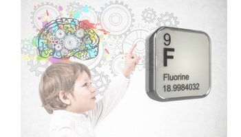 Young child points to Fluorine element