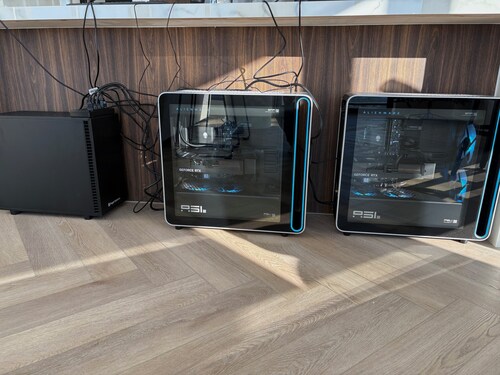 Image of our offline systems: a workstation running a 1 trillion parameter LLM entirely offline, and two Alienware towers running a 235B and 120B LLM