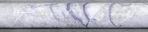 Figure 8: Massive pollucite with lepidolite veining in drill hole CV25-885 at ~240 m depth (core length) at the CV5 Pegmatite’s southwestern extension. Core graded 0.5 m at 17.9% Cs2O over sample interval (240.2 m to 240.7 m). (CNW Group/PMET Resources Inc.)