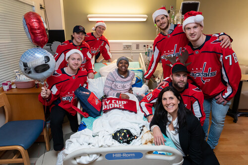 Hope for Henry Founder and CEO Laurie Strongin and the Washington Capitals join MedStar Health on a holiday visit to pediatric patients at MedStar Georgetown University Hospital in 2018.