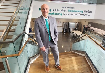 Drew Stanley stands in front of FMFCU's mission statement at its Chadds Ford, PA headquarters.