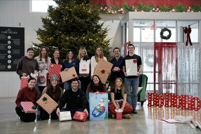Members of the Everlight team celebrate wrapping gifts for Wisconsin families and children.