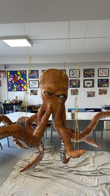 Shrub Oak International School student creates giant paper-mache octopus for under-the-sea themed winter student art showcase.