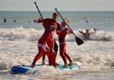 Surfing Santas Take Over Cocoa Beach. Surfing Santas Take Over Cocoa Beach.