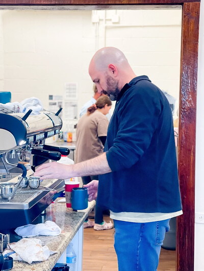 Frothing milk at an espresso machine inside the new  State Street Coffee and Ice Cream in Elberta, Ala.