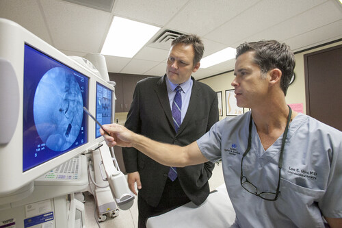 Spine surgeon Eeric Truumees, MD consults with physical medicine MD Dr. Lee Moroz at Texas Spine & Scoliosis in Austin, Texas.