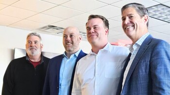 Dereck Jacques and Foster Charles from Charles IT pose for a photo with MERIT CTO, Larry Robertson (Left) and MERIT CEO, Pete Peterson (Right).