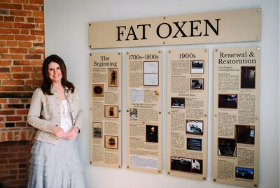 Kristin LeDuc, founder of Porch Nook, stands beside the completed interpretive history panels at the historic Fat Oxen House in Urbana, Maryland. LeDuc led the research, creative direction, and curation of the installation, which traces the site’s history from Indigenous stewardship through 20th-century restoration.