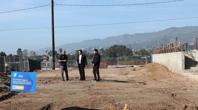 Jim Kirtley, Executive Director at Lowe Family YMCA, formerly Palisades-Malibu YMCA, left, talks with BofA's Raul Anaya and Mario Valenzuela of the YMCA of Metro Los Angeles at the site of the burned club