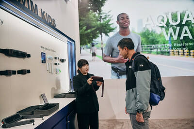 Photo credit: WIRobotics. WIRobotics’ WIM series on display at CES 2026, as a visitor receives an explanation of the WIM S.